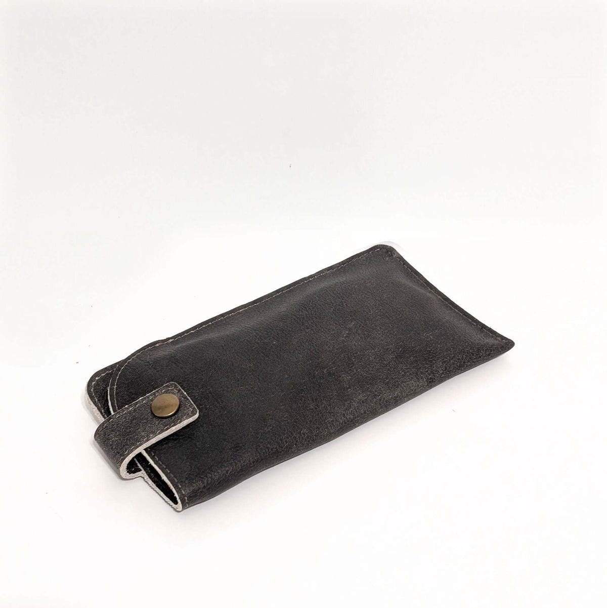 Leather Eyeglass Case in dark color with snap closure for secure storage of glasses.
