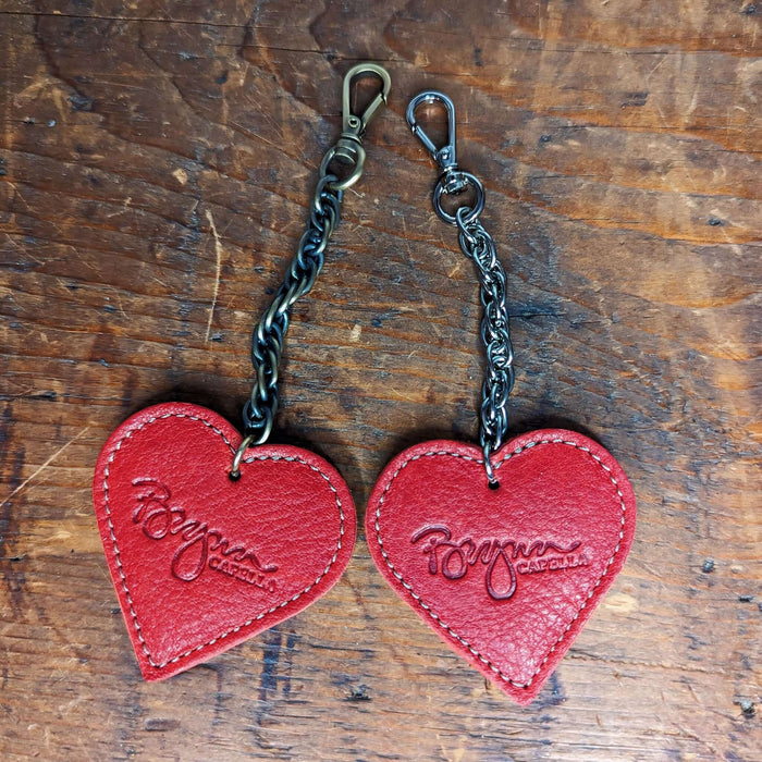 Red heart bag charm made from full grain leather with antique brass chain, perfect for bag charms and gifts.