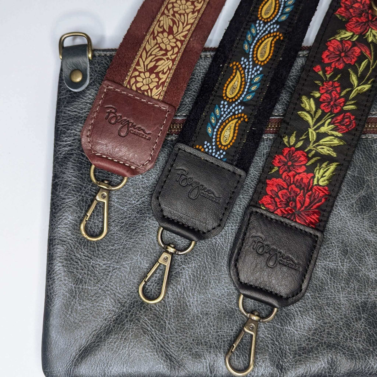 Close-up of three guitar bag straps with floral and paisley designs, showcasing the Lizzy Guitar Bag Strap - Golden Paisley.