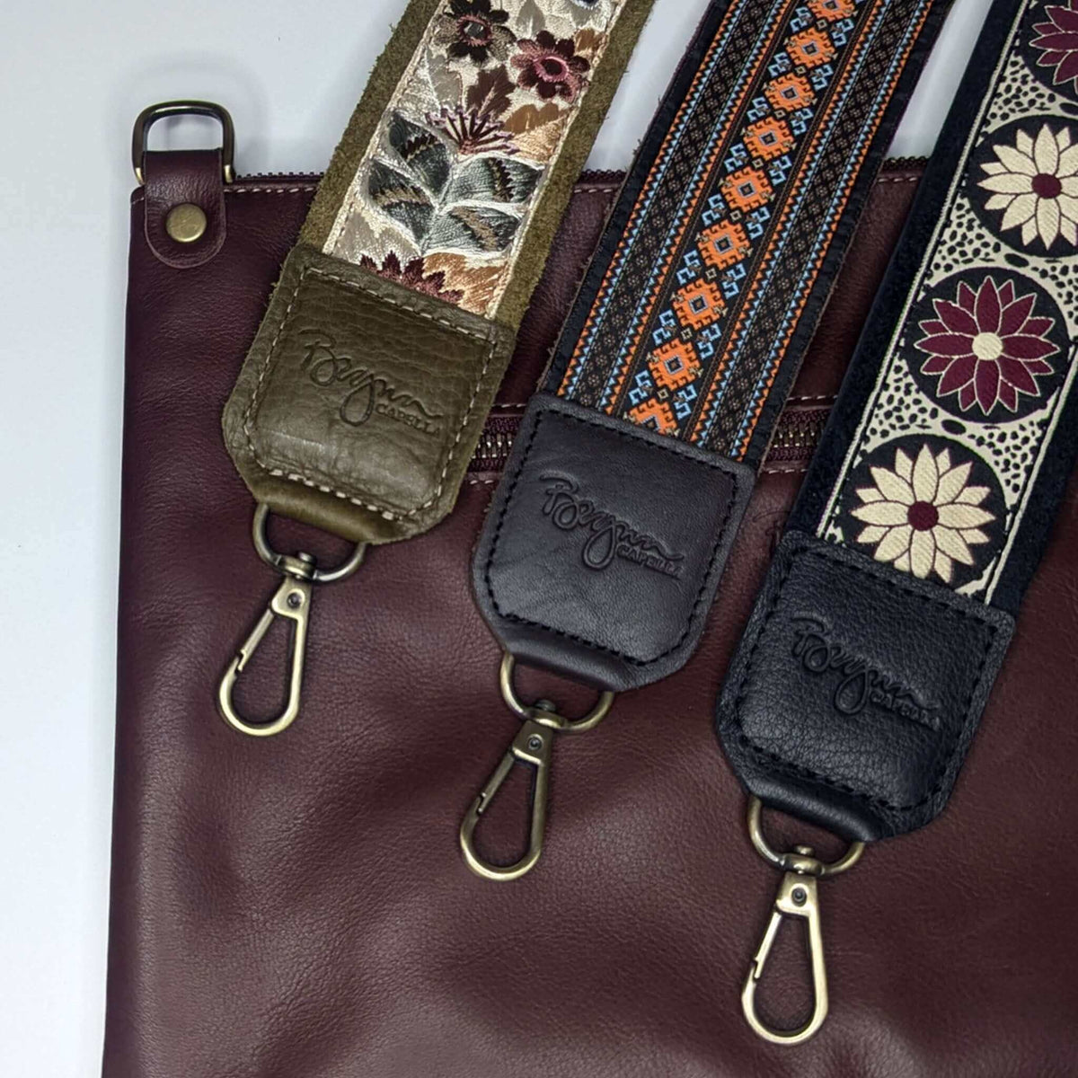 Guitar Bag Strap collection featuring decorative woven prints and leather trims on a maroon handbag.