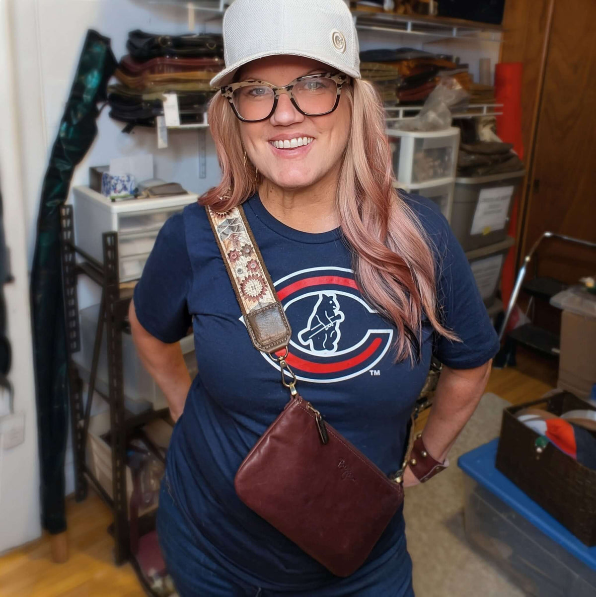 Designer Brynn Capella showing off her merlot Cher mini crossbody with Chocoloate Sunflower Lizzy strap