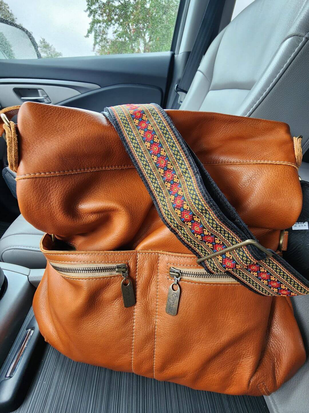 Original Lauren leather crossbody bag in whiskey color with decorative strap, showcasing versatility of leather crossbody bag.