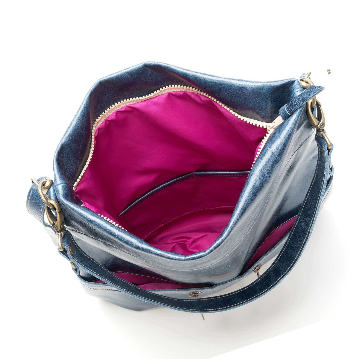 Interior view of the Lauren Crossbody - Cape Cod, featuring a vibrant pink lining in a leather crossbody bag.
