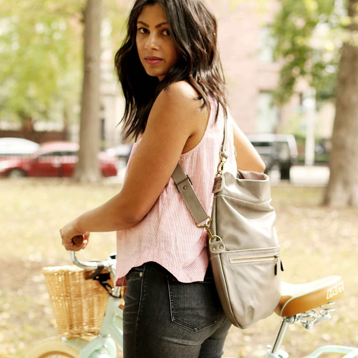 Woman wearing an Original Lauren 6-in-1 leather crossbody bag in outdoor setting.