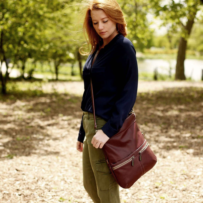 Woman wearing a Mini Lauren leather crossbody bag in a natural outdoor setting.