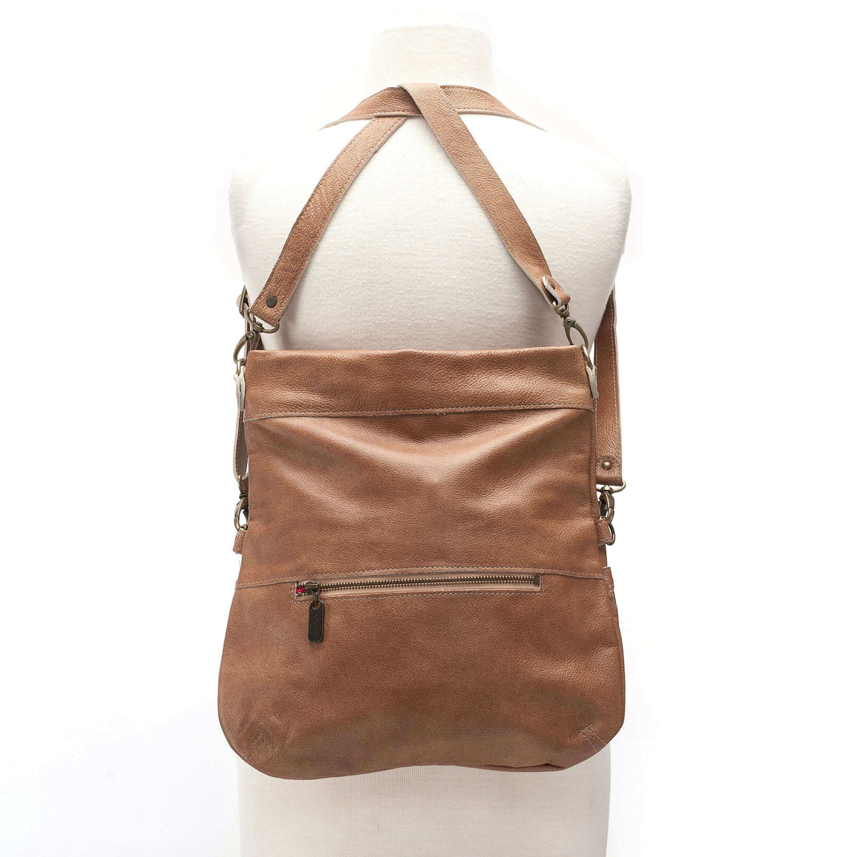 Mini Lauren leather crossbody bag shown in brown, demonstrating its convertible backpack style.