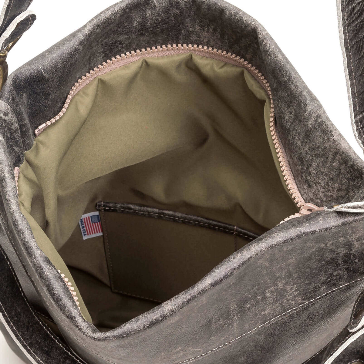Inside view of the Mini Lauren leather crossbody bag showcasing its spacious interior and pocket.
