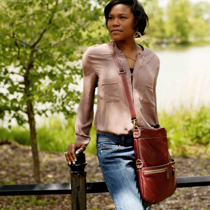 Model wearing Original Lauren leather crossbody bag in a natural setting.